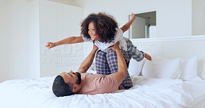 Dad, daughter and airplane on bed with playing, bonding and freedom for happiness or trust in bedroom of home. Family, man and girl child with lifting in knees with balance, relationship and love