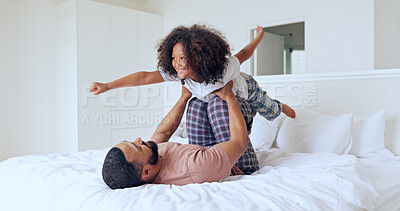 Buy stock photo Dad, daughter and airplane on bed with playing, bonding and freedom for happiness or trust in bedroom of home. Family, man and girl child with lifting in knees with balance, relationship and love