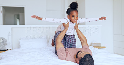 Buy stock photo Father, daughter and airplane on bed with playing, bonding and freedom for happiness or trust in bedroom of home. Family, man and girl child with lifting in knees with balance, relationship and love