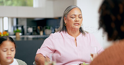 Buy stock photo Praying, senior woman and family at table for dinner, lunch or breakfast and holding hands for grace. Christian, religion and grandmother with girl giving gratitude, prayer or thank you god for food