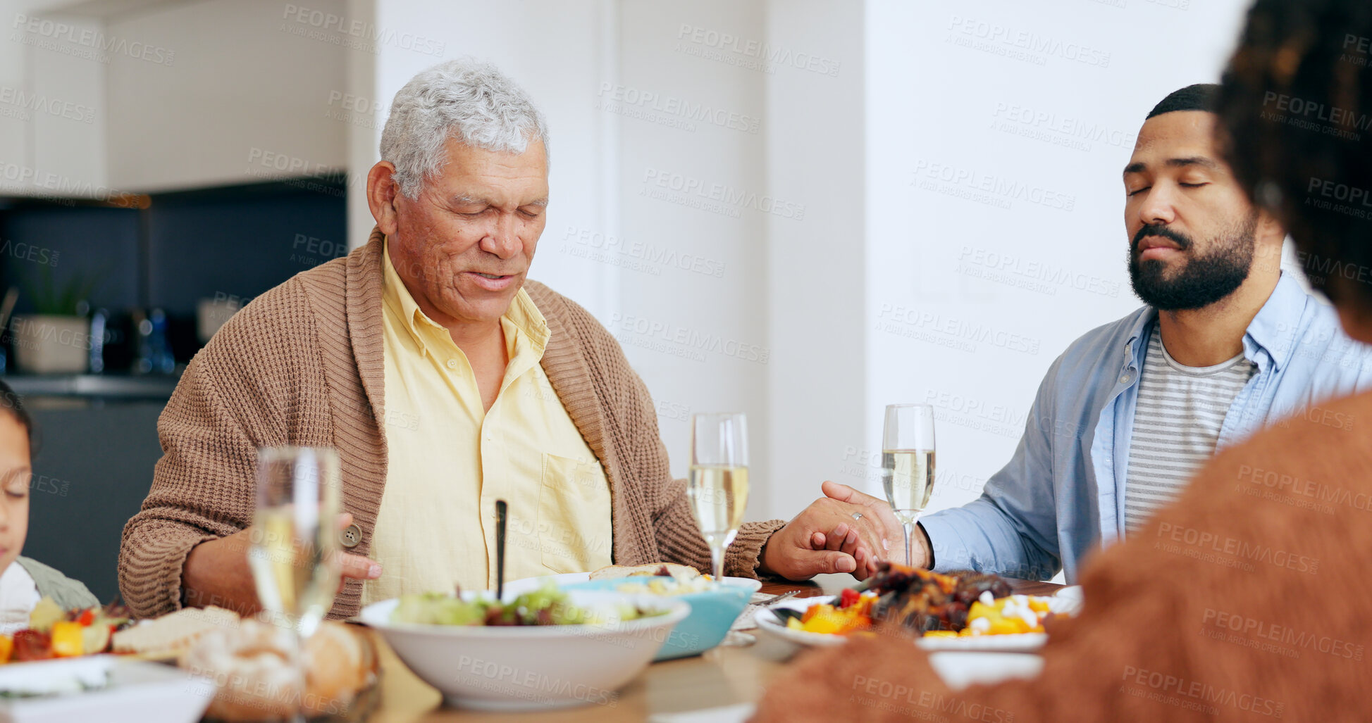 Buy stock photo Food, thanksgiving and a family praying at the dinner table of their home together for eating a celebration meal. Love, holidays and a group of people saying grace for health, diet or nutrition