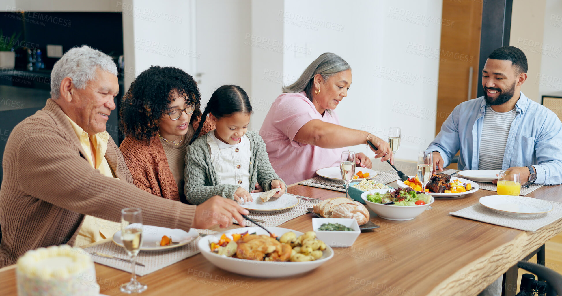 Buy stock photo Happy family, food and smile in dining room of home for dinner, lunch or event for bonding and care. People, parents and grandparents with child at table in lounge for celebration, love and smile