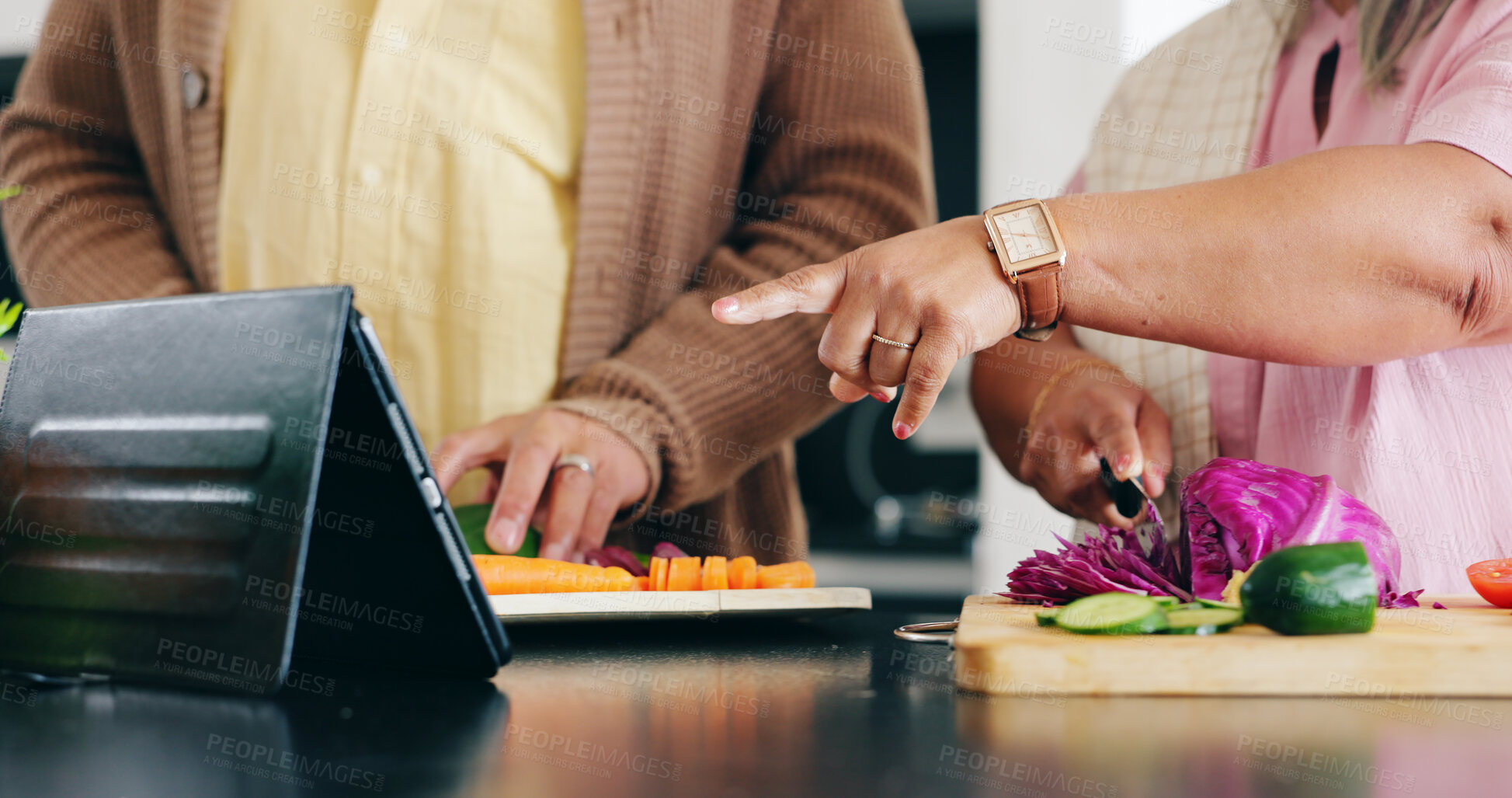 Buy stock photo Senior, hands and cooking in kitchen with tablet for dinner, lunch or vegetables with support, help and love. Elderly, man and woman with pointing, peace and nutrition for bonding or relationship