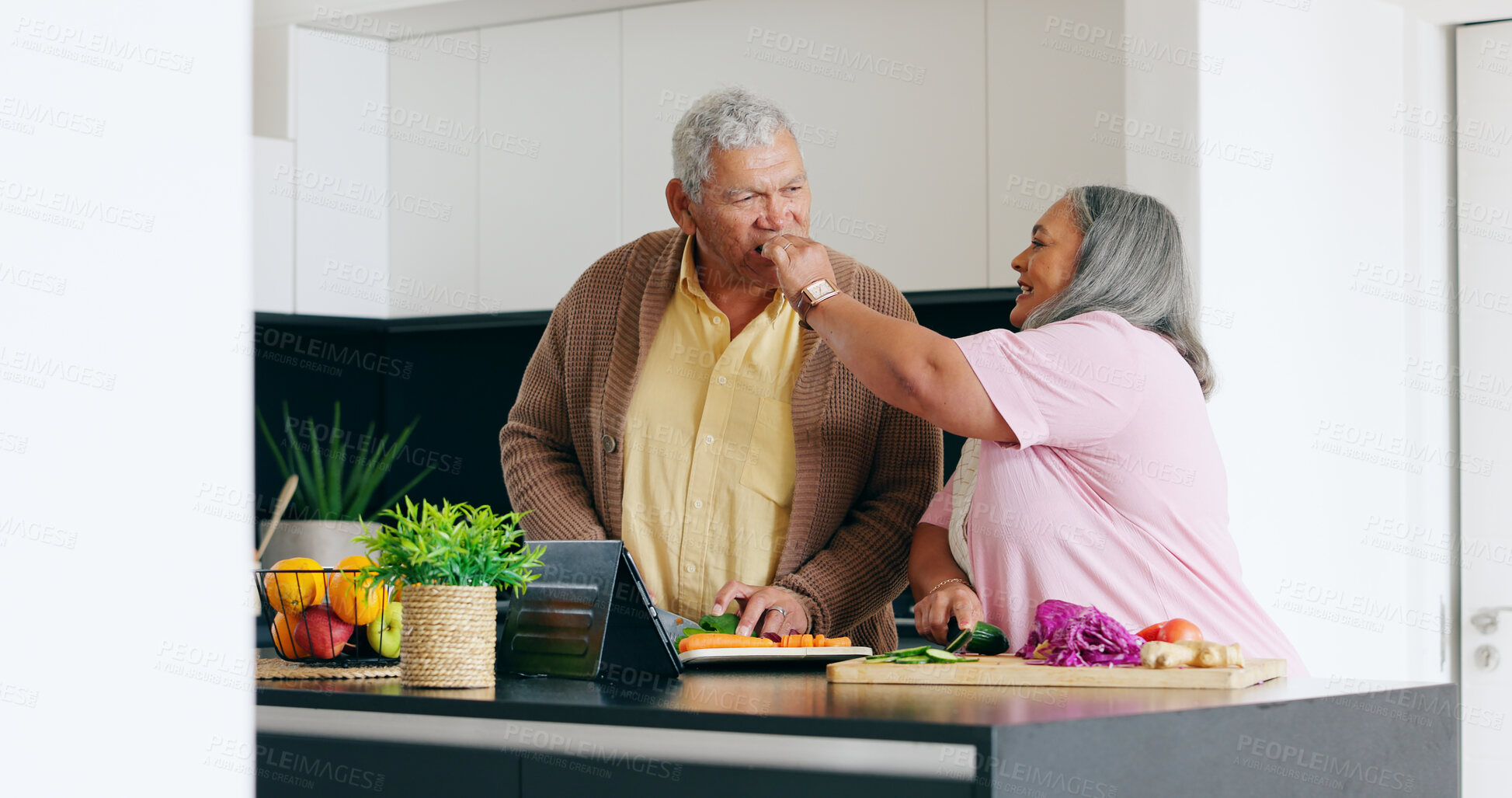 Buy stock photo Senior couple, cooking and taste in a kitchen with tablet for recipe, research or online tutorial at home. Love, food and old people with digital app for nutrition, blog or vegetables for meal prep