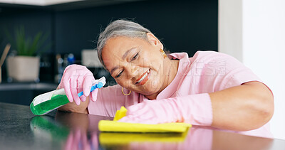 Buy stock photo Cleaning, mature or woman by detergent on kitchen counter, housekeeper pride or smile for home hygiene. Happy, person and hand for housekeeping to shine, sanitizer and disinfectant surface in house