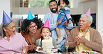 Birthday cake, family and child blow candles with grandparents for celebration, party and singing or clapping. Happy interracial people, mother and father with girl kids for special holiday at home