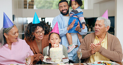 Birthday cake, family and child blow candles with grandparents for celebration, party and singing or clapping. Happy interracial people, mother and father with girl kids for special holiday at home