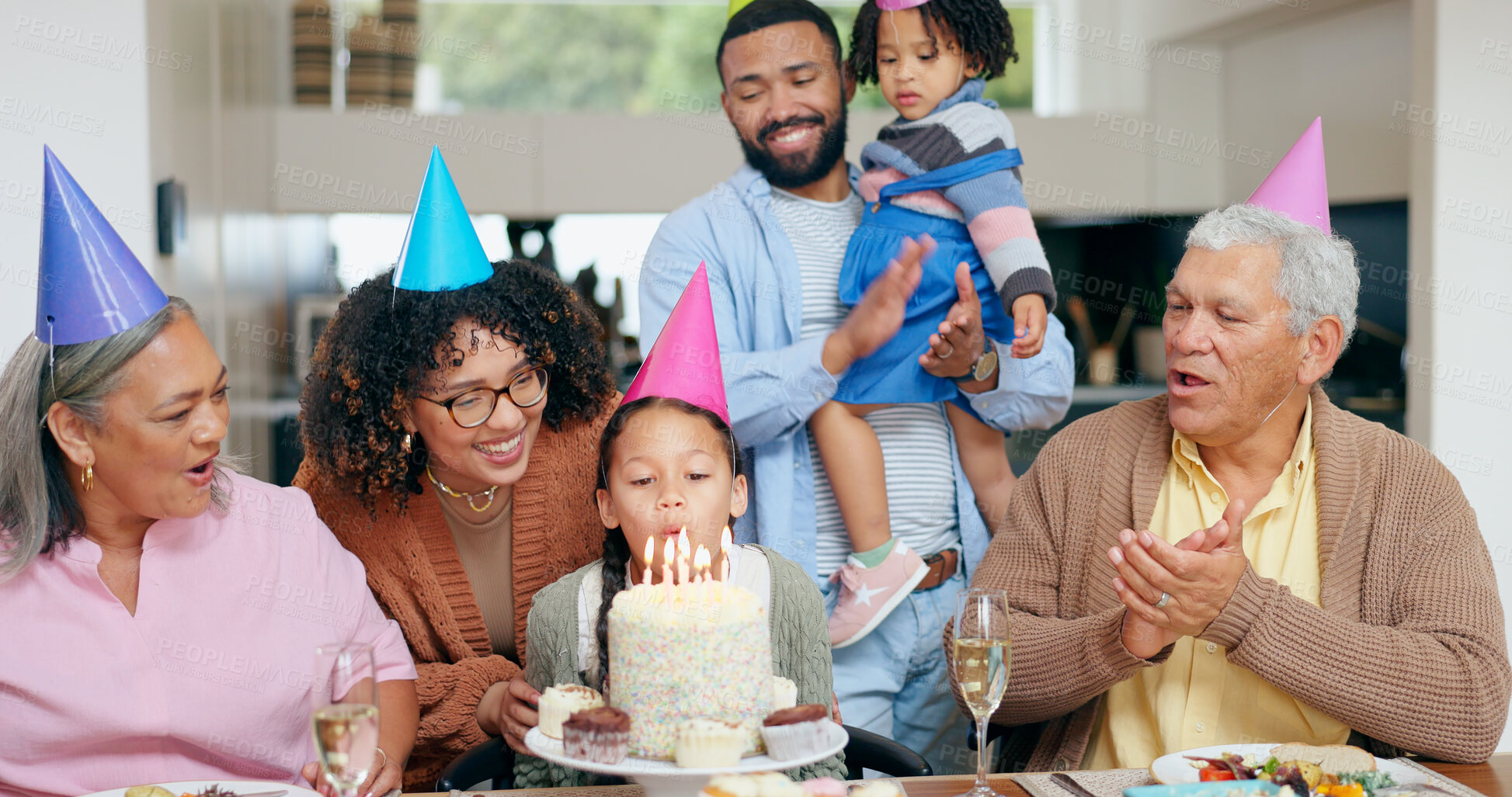 Buy stock photo Birthday cake, family and child blow candles with grandparents for celebration, party and singing or clapping. Happy interracial people, mother and father with girl kids for special holiday at home