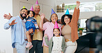 Happy family, birthday hats and celebration for party, children and parents. House, grandparents and photography with timer, excited and cheers with hands, wow and bonding together for memories
