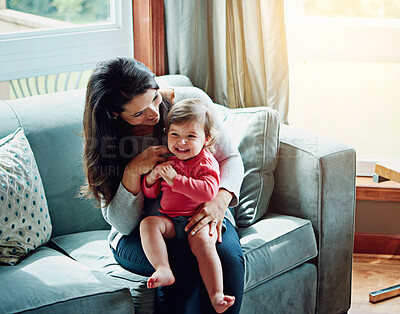 Buy stock photo Shot of a mother bonding with her adorable little daughter at home