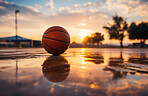 Basketball, outdoor and court with ball on floor for athletic competition or recreation low angle. Exercise, cardio and basketball court ground with sunset for sports, match or workout.