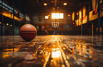 Basketball, indoor and court with ball on floor for athletic competition, fitness and recreation low angle. Exercise, cardio and texture of sports equipment for training, match and workout at sunset.