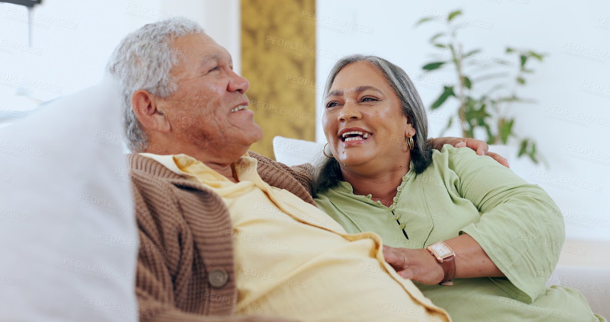 Buy stock photo Senior, couple or laughing on sofa for love, bonding and relationship with joke, comic or happy in living room. Elderly, man or woman on couch with smile for support, care and relax in lounge of home