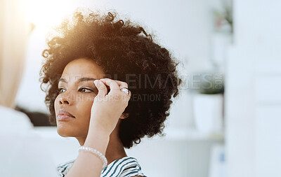 Buy stock photo Woman, beauty and face with makeup artist for eyeshadow, blush or foundation by hand. Black model, hair or afro with determined, expression or look for application of cosmetic product with lens flare
