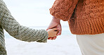 Couple, holding hands and ocean for love, care or support in trust, travel or outdoor getaway together. Closeup of man and woman touching in romance for unity, bonding or compassion on beach coast