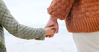 Buy stock photo Parent, child and holding hands at ocean for love, care or support in trust, travel or outdoor getaway. Closeup of person with kid for unity, bonding or compassion on beach or sea coast together