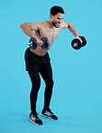 Fitness, dumbbells and man with workout, exercise and training with wellness on blue background. Person, model and bodybuilder with equipment, challenge and progress with muscle development or health