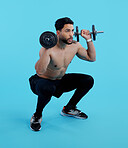 Man, fitness and squat with dumbbells for weightlifting, bodybuilding against a blue studio background. Male person or bodybuilder lifting weights for strength workout, exercise or training on mockup