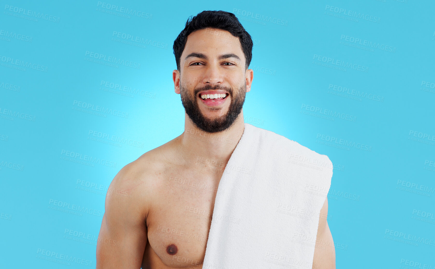 Buy stock photo Shower, portrait and happy man in studio with towel for body care, wellness or grooming on blue background. Face, smile and model smile for beauty results, treatment or glow from bathroom routine 