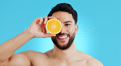 Buy stock photo Orange, skincare or portrait of man in studio for vitamin C, natural cosmetics or healthy diet on blue background. Fruit, beauty and model face with citrus skin detox, cleaning or wellness nutrition