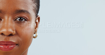 Buy stock photo Mockup space, studio and portrait of black woman on blue background for news, information and beauty. Model, closeup and half face of African person with cosmetics, makeup and dermatology 