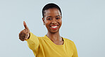 Happy black woman, portrait and thumbs up in winning, success or good job against a gray studio background. African female person smile with like emoji, yes sign or thank you for approval or mockup