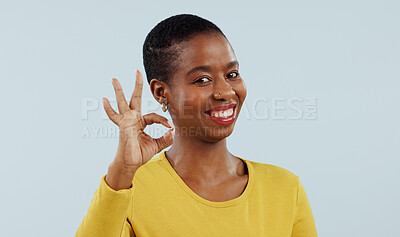 Buy stock photo Happy black woman, portrait and OK sign for success or approval against a gray studio background. Face of African female person or model smile with like emoji, yes or okay for perfect or good job