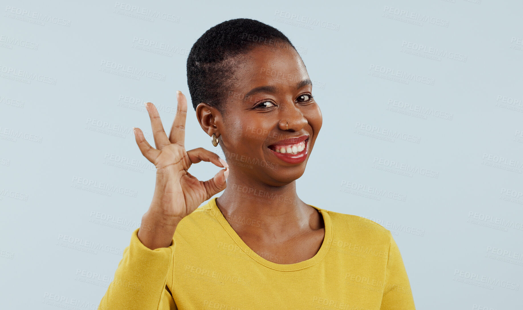 Buy stock photo Happy black woman, portrait and OK sign for success or approval against a gray studio background. Face of African female person or model smile with like emoji, yes or okay for perfect or good job