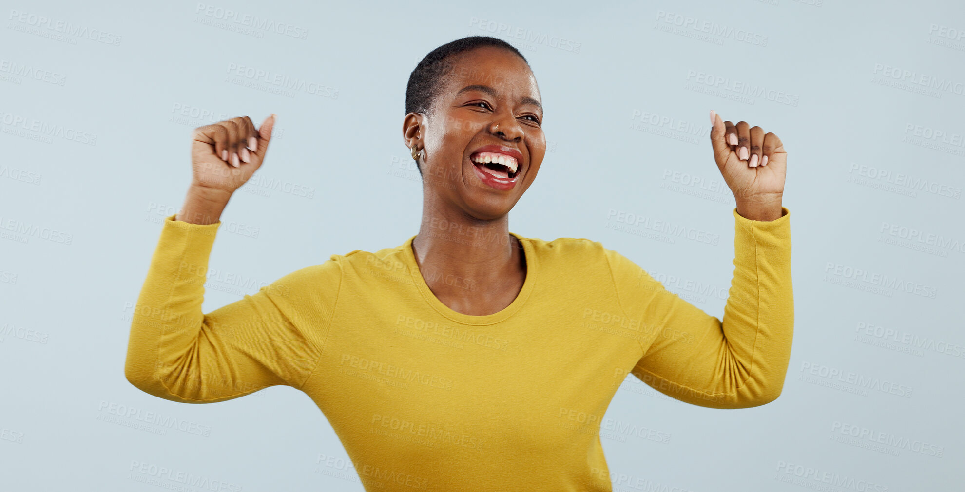 Buy stock photo Excited black woman, dancing and celebration for winning or promotion against a gray studio background. Face of happy African female person or model in joy or satisfaction for bonus or good news