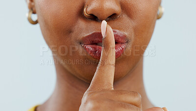 Buy stock photo Black woman, mouth and lips in secret for gossip, privacy or confidential information against a studio background. Closeup of African female person with finger or emoji in silence, quiet or whisper