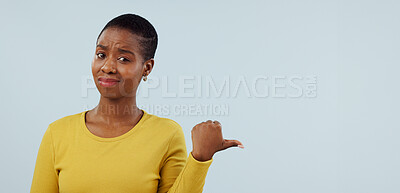 Buy stock photo Disappointed, pointing and portrait of black woman in studio with why, question and doubt. Emoji, what and face of person with hand gesture for announcement, information and news on blue background