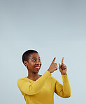 Mockup, smile and black woman with hand pointing up in studio for presentation on grey background. News, announcement and African female model show feedback, checklist or schedule, promo or platform 