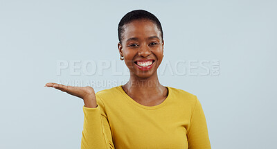 Buy stock photo Happy black woman, portrait smile and palm for advertising or marketing against a studio background. Face of African female person sign with hand out showing advertisement or offer on mockup space