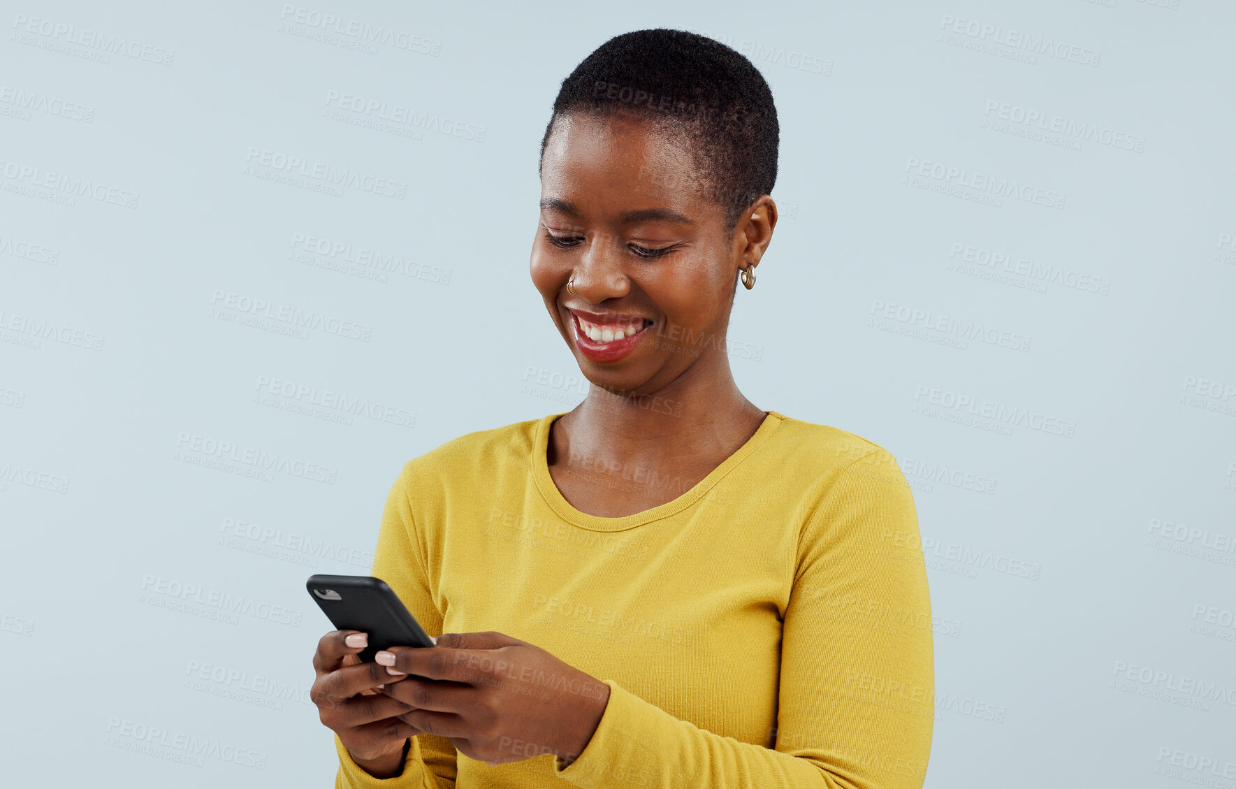 Buy stock photo Happy black woman, phone and communication for social media against a blue studio background. Face of African female person smile on mobile smartphone for online chatting, texting or search on mockup