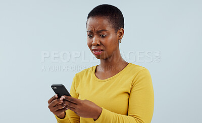 Buy stock photo Frustrated black woman, phone and shocking news on social media, terrifying or bad against a studio background. Disturbed face of African female person on mobile smartphone for alert or notification