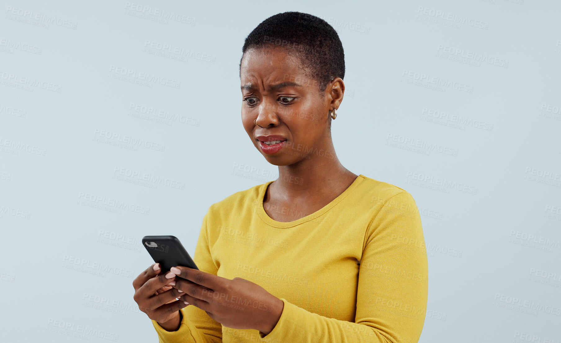 Buy stock photo Frustrated black woman, phone and shocking news on social media, terrifying or bad against a studio background. Disturbed face of African female person on mobile smartphone for alert or notification