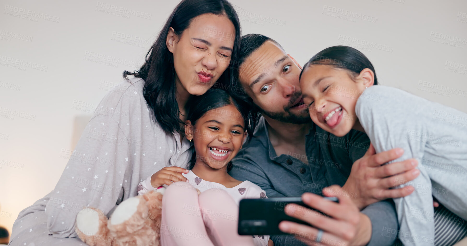 Buy stock photo Funny family selfie, parents and kids in bedroom, hug and bonding together for love or goofy memory in home. Photography, love and mom, dad and children on bed with smile, relax playful fun in house.