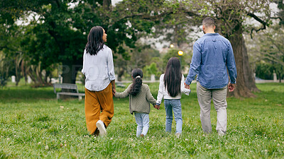 Buy stock photo Family, holding hands and walking in park from the back with love and care together in nature. Travel, insurance and parents with children to support on adventure, journey or holiday in countryside