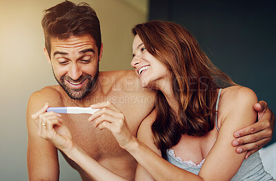 Buy stock photo Shot of a young couple at Shot of a young couple looking at the results on a pregnancy test