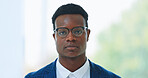 Portrait, glasses and serious with business black man in an office for corporate of professional work. Face, mission and mindset with a young employee in a workplace for growth or company development