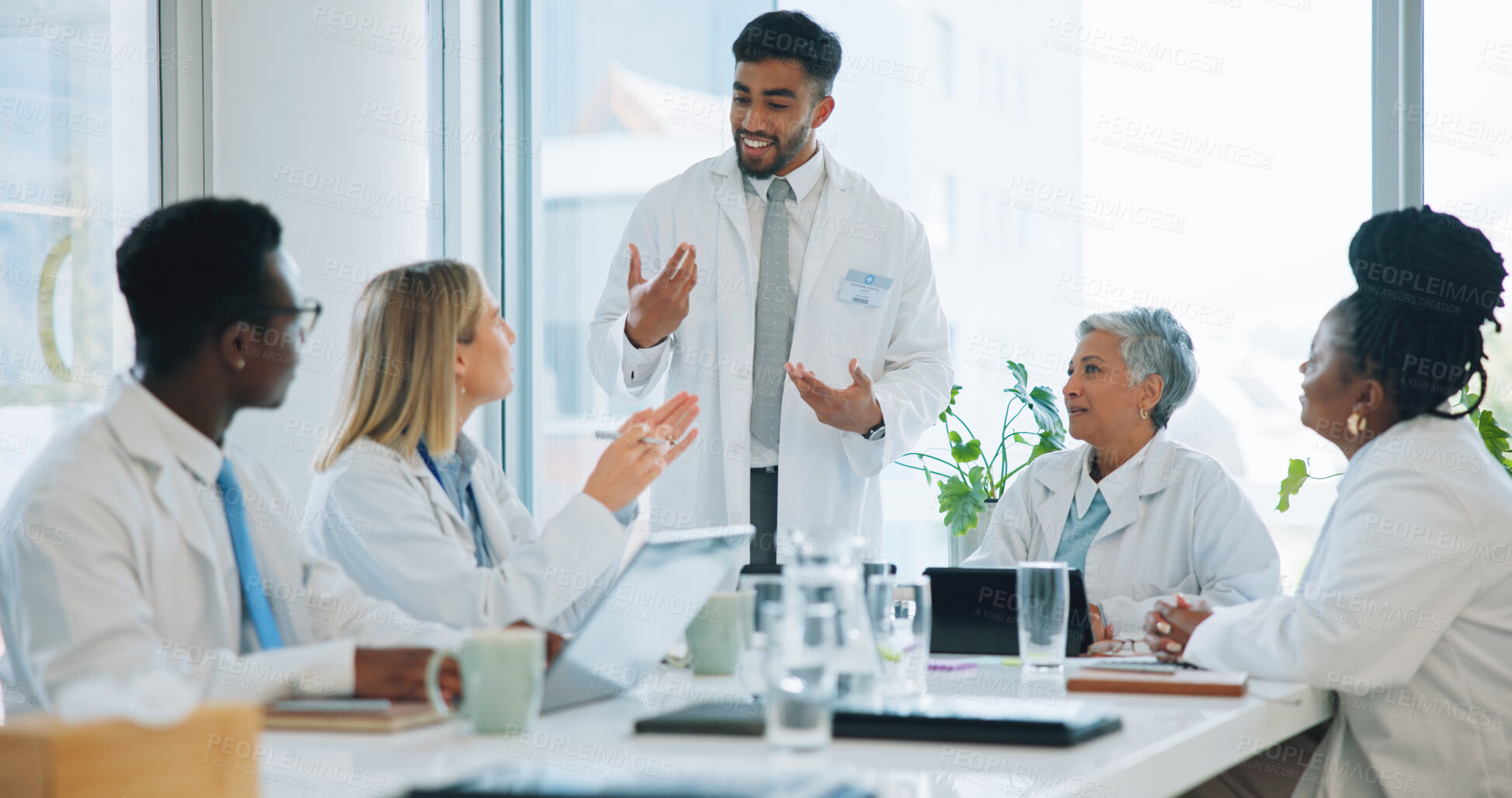 Buy stock photo Man, doctor and team in meeting for healthcare, planning or strategy together at hospital or office. Group of medical employees in teamwork, discussion or collaboration for presentation at clinic