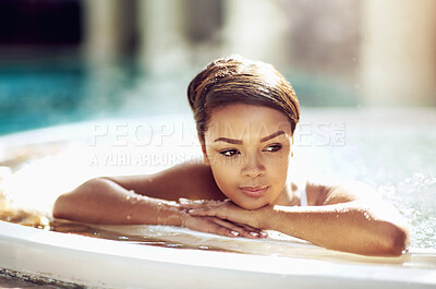 Buy stock photo Shot of an attractive young woman relaxing in an indoor jacuzzi at a beauty spa