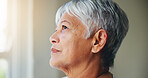 Senior woman, thinking and looking out window in memory, ambition or dreaming in retirement home. Closeup or face of mature female person in wonder, contemplating or thought for idea or hope at house
