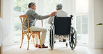 Elderly man, comfort and woman in wheelchair, touch and support partner in retirement with love. Senior couple, care and hand for together in marriage, sickness and health for wellness in family home