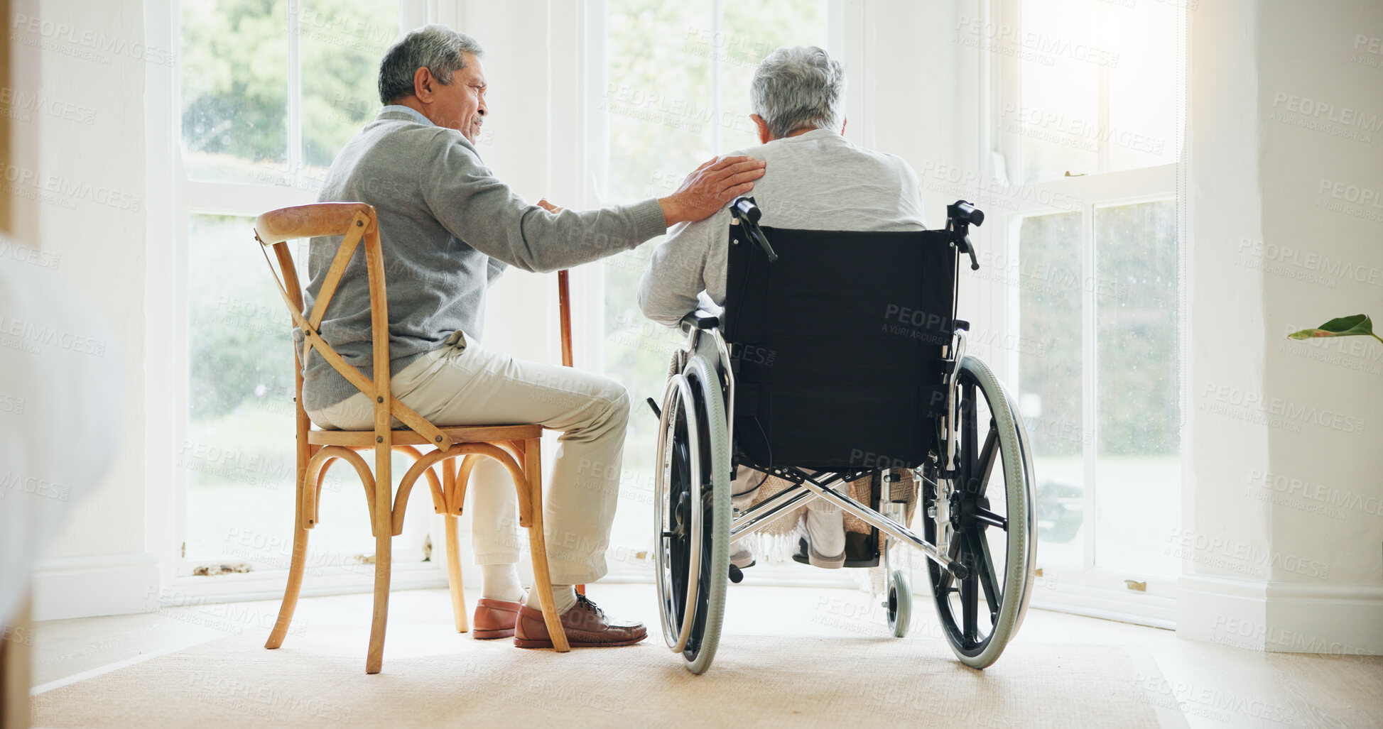 Buy stock photo Elderly man, comfort and woman in wheelchair, touch and support partner in retirement with love. Senior couple, care and hand for together in marriage, sickness and health for wellness in family home