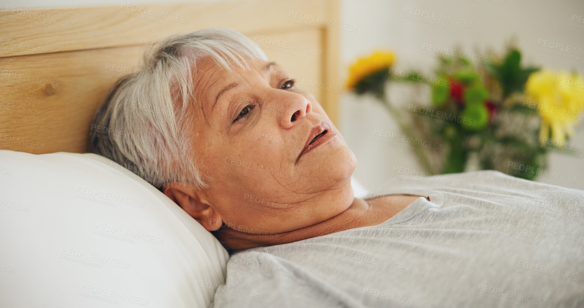 Buy stock photo Depression, tired and an elderly woman in bed for peaceful rest or to relax in her retirement home closeup. Face, morning or insomnia with a senior person exhausted in the bedroom of an apartment