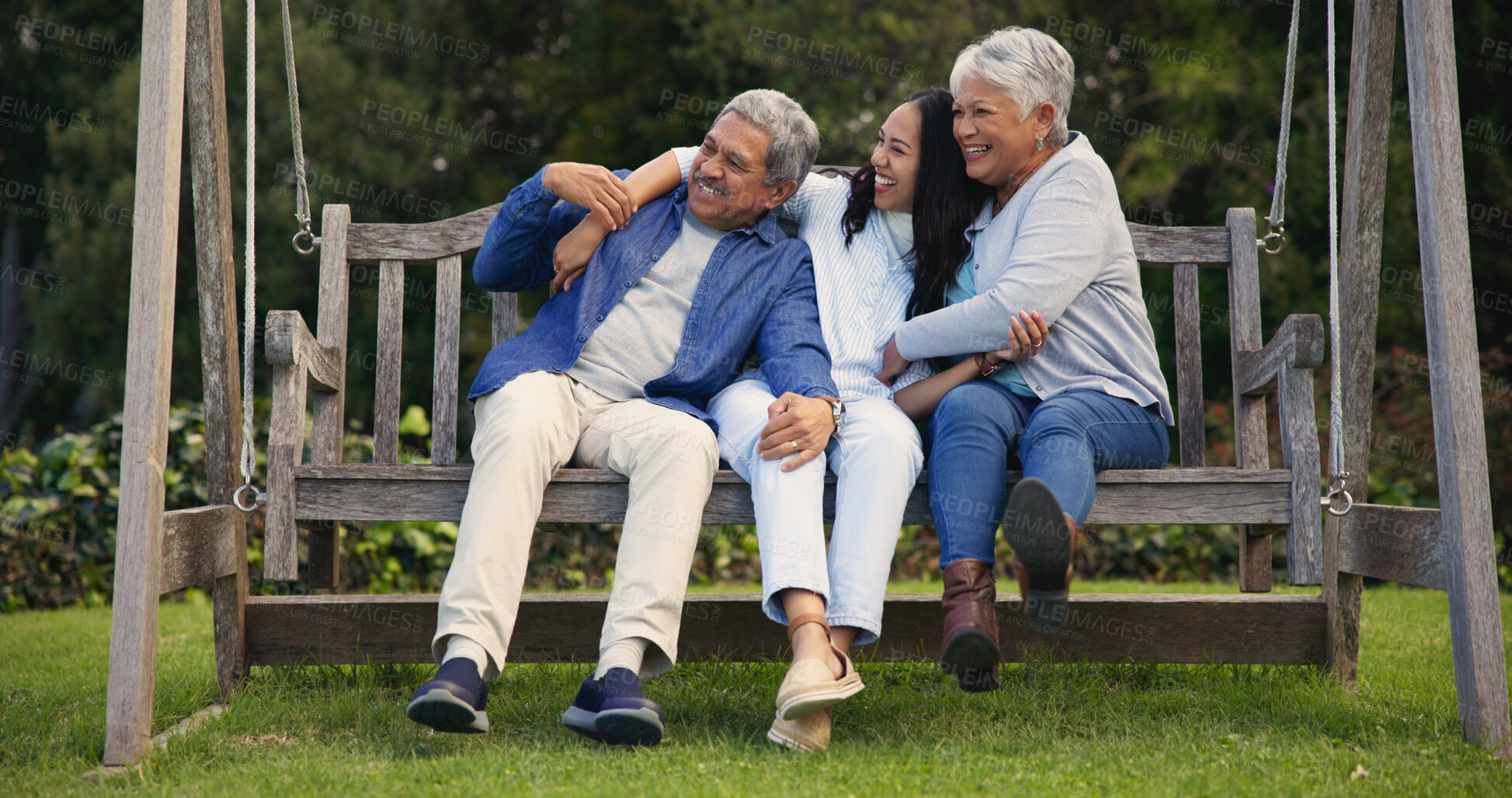 Buy stock photo Senior parents, hug or woman on bench with laughing, nature or bonding with goofy on retirement. Mature man, mother or older daughter for together in comic joke, lounge or embrace for love in garden 