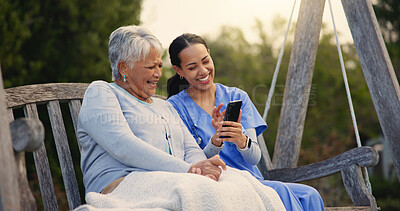 Buy stock photo Outdoor, bench and nurse with senior woman, cellphone and connection with social media, conversation and internet. Pensioner, outdoor and caregiver with elderly person, smartphone and typing with app