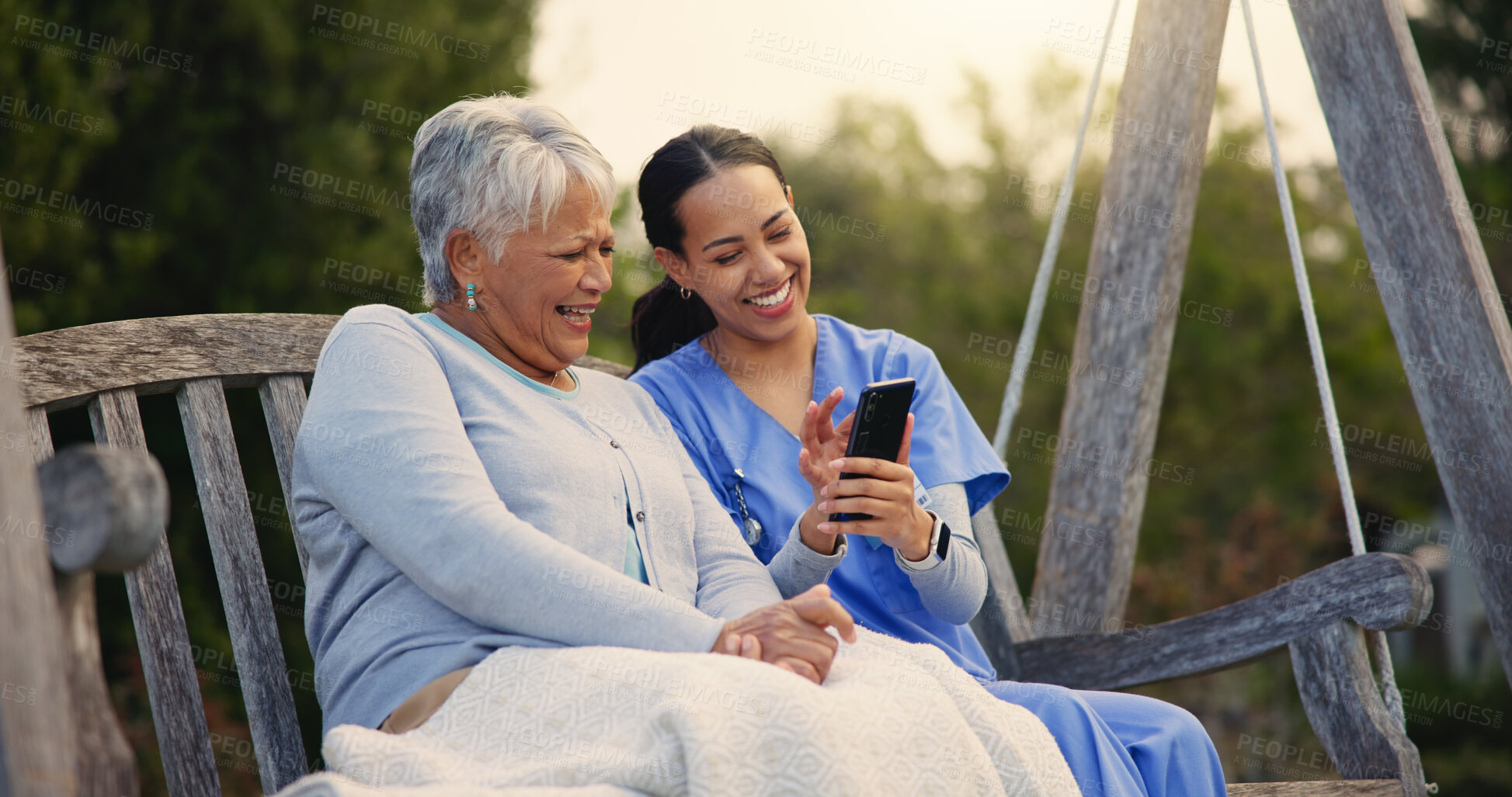 Buy stock photo Outdoor, bench and nurse with senior woman, cellphone and connection with social media, conversation and internet. Pensioner, outdoor and caregiver with elderly person, smartphone and typing with app