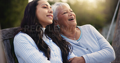 Buy stock photo Happy, senior and mother with woman on bench, nature and bonding hug for laugh on retirement. Mature person, parent and older daughter for together in park, care and love with funny joke in garden